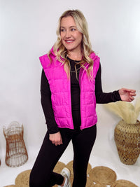 Hot Pink Zip-Up Puffer Vest with side slits and side pockets, perfect for layering in cooler spring weather.