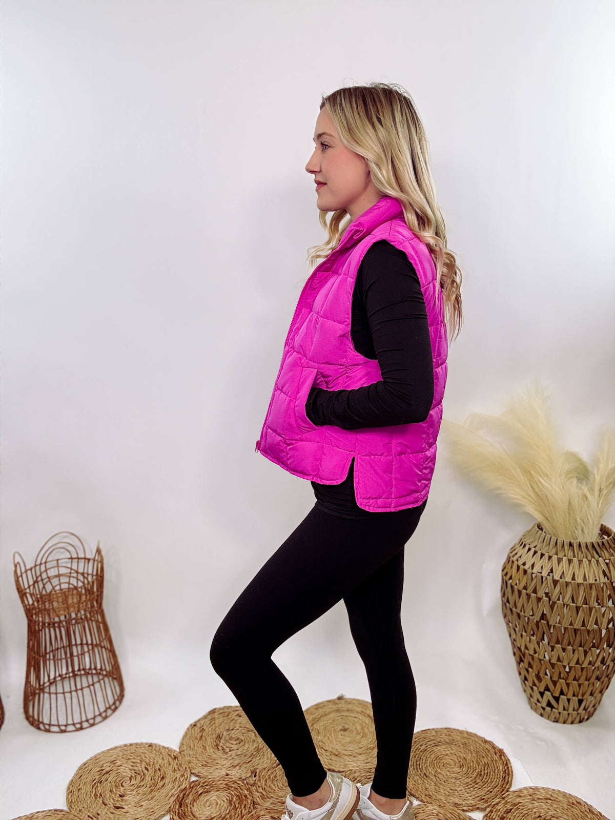 Hot Pink Zip-Up Puffer Vest with side slits and side pockets, perfect for layering in cooler spring weather.