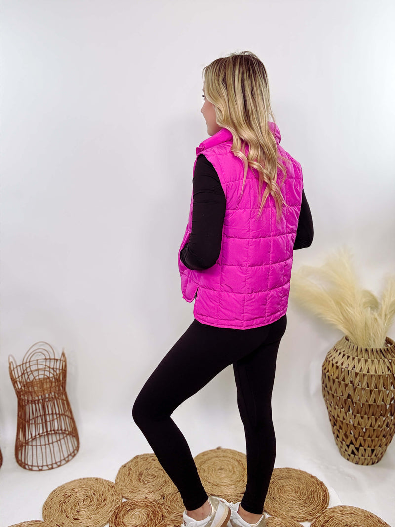 Hot Pink Zip-Up Puffer Vest with side slits and side pockets, perfect for layering in cooler spring weather.