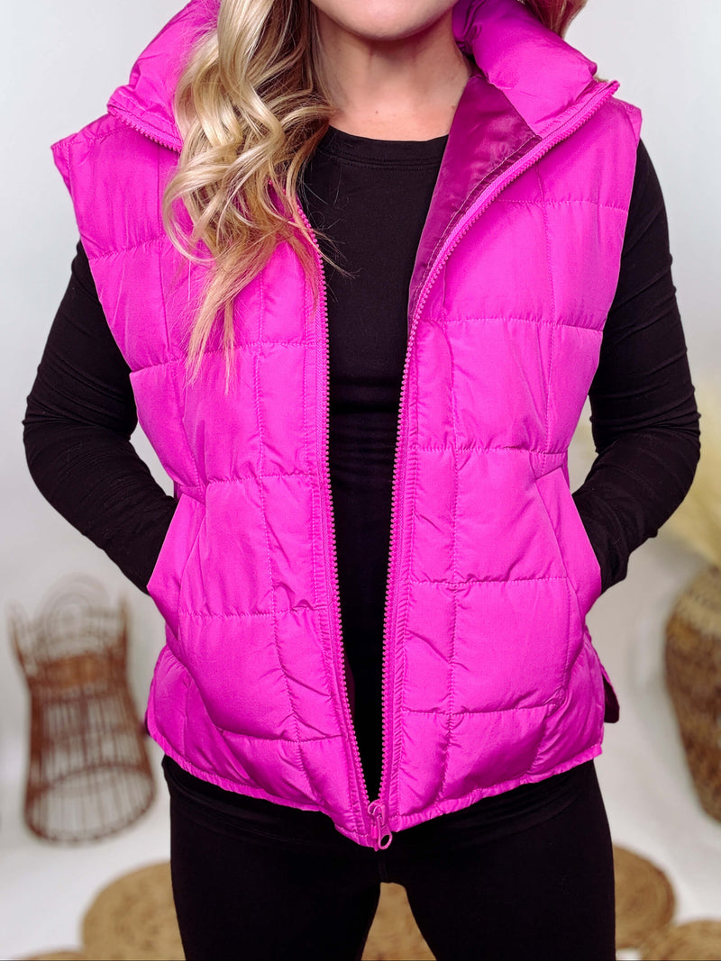 Hot Pink Zip-Up Puffer Vest with side slits and side pockets, perfect for layering in cooler spring weather.