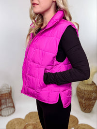 Hot Pink Zip-Up Puffer Vest with side slits and side pockets, perfect for layering in cooler spring weather.