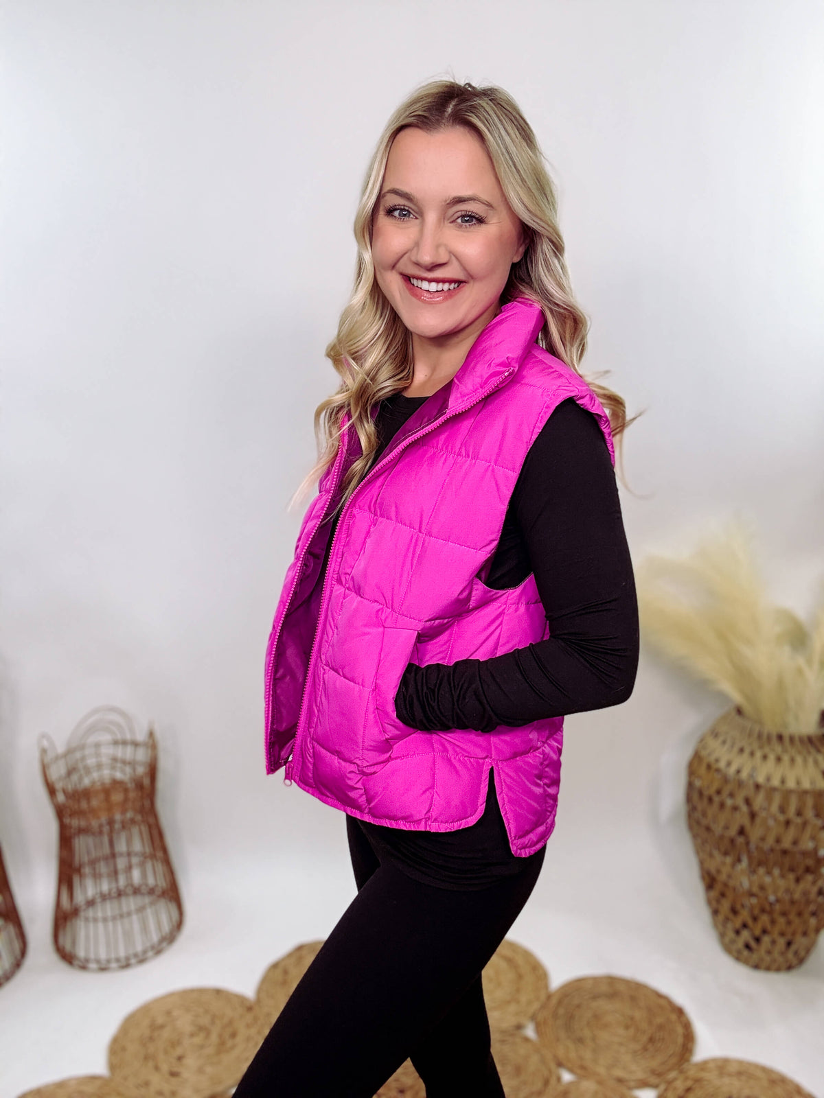 Hot Pink Zip-Up Puffer Vest with side slits and side pockets, perfect for layering in cooler spring weather.