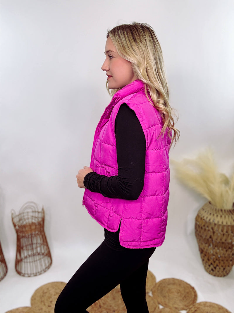 Hot Pink Zip-Up Puffer Vest with side slits and side pockets, perfect for layering in cooler spring weather.