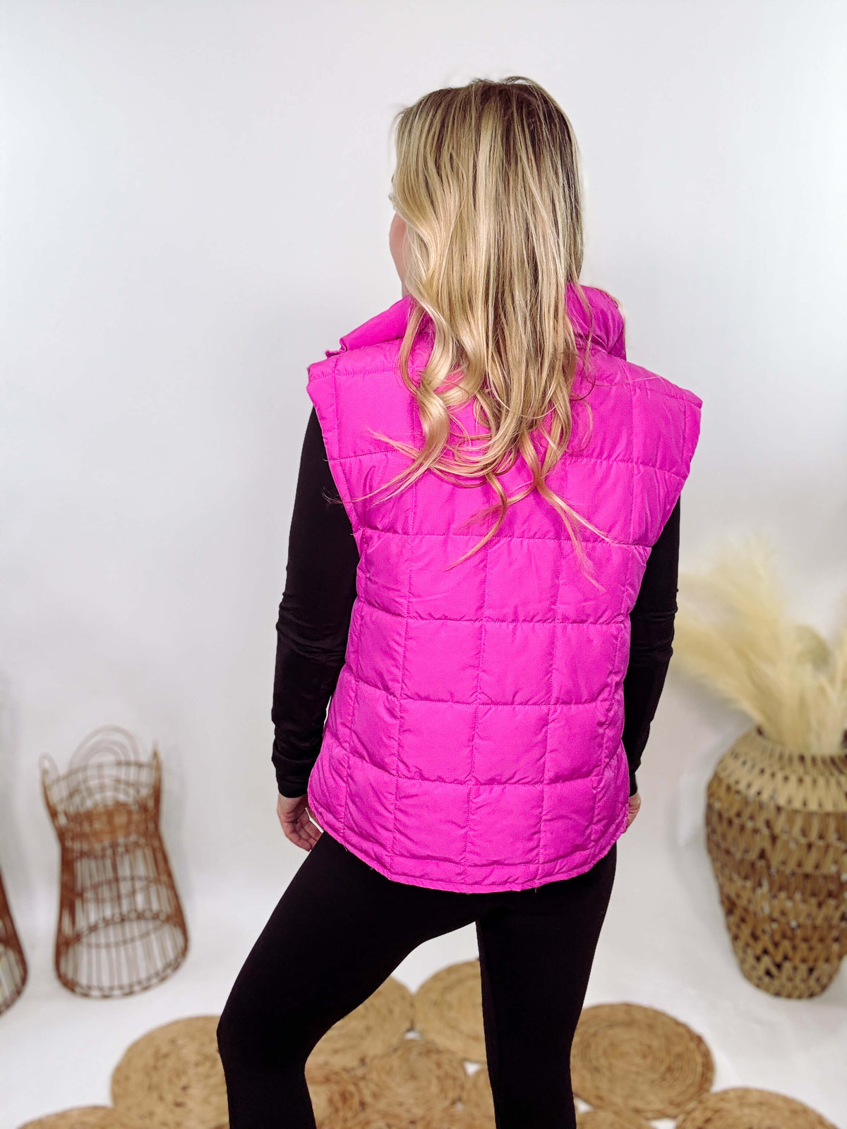 Hot Pink Zip-Up Puffer Vest with side slits and side pockets, perfect for layering in cooler spring weather.