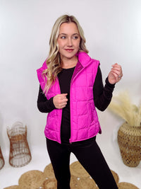 Hot Pink Zip-Up Puffer Vest with side slits and side pockets, perfect for layering in cooler spring weather.