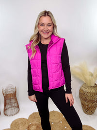 Hot Pink Zip-Up Puffer Vest with side slits and side pockets, perfect for layering in cooler spring weather.