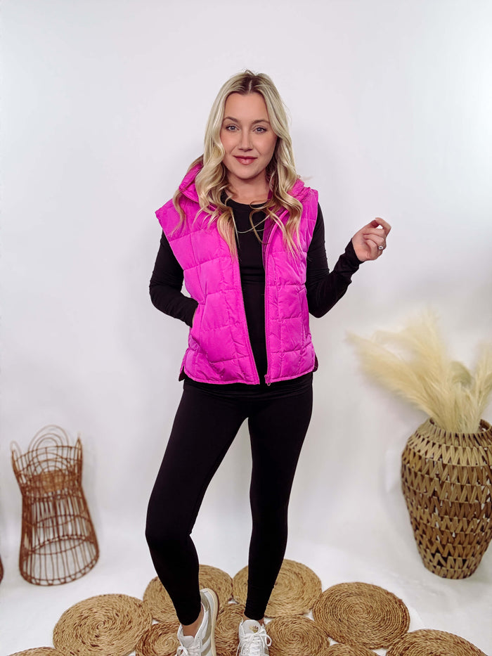 Hot Pink Zip-Up Puffer Vest with side slits and side pockets, perfect for layering in cooler spring weather.