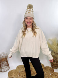 Creamy White Oversized Long Sleeve Sweater with a relaxed crew neckline, drop shoulders, ribbed knit cuffs and hem, and a soft, stretchy acrylic fabric.