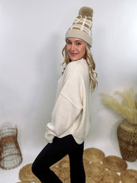 Creamy White Oversized Long Sleeve Sweater with a relaxed crew neckline, drop shoulders, ribbed knit cuffs and hem, and a soft, stretchy acrylic fabric.