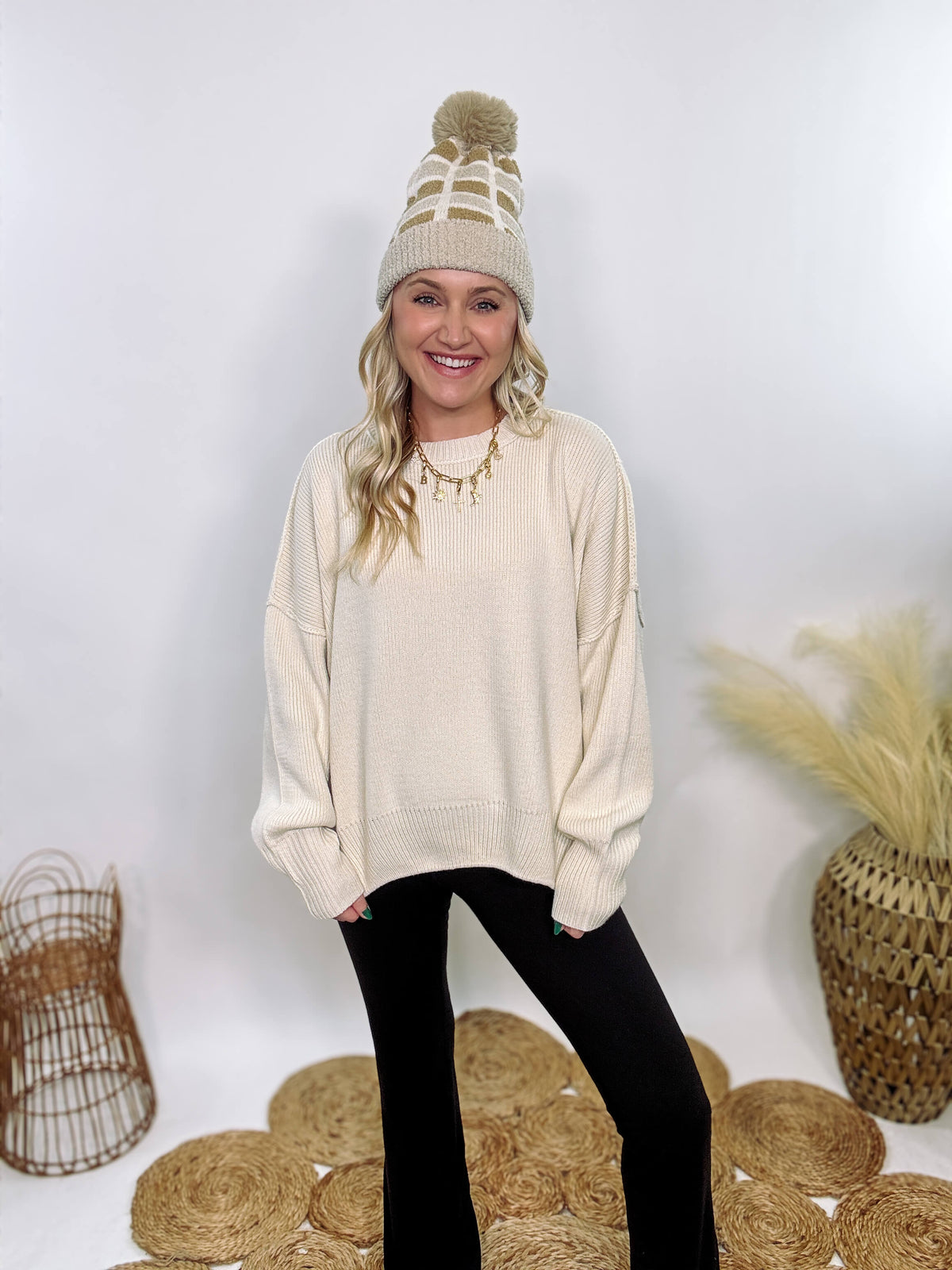 Creamy White Oversized Long Sleeve Sweater with a relaxed crew neckline, drop shoulders, ribbed knit cuffs and hem, and a soft, stretchy acrylic fabric.