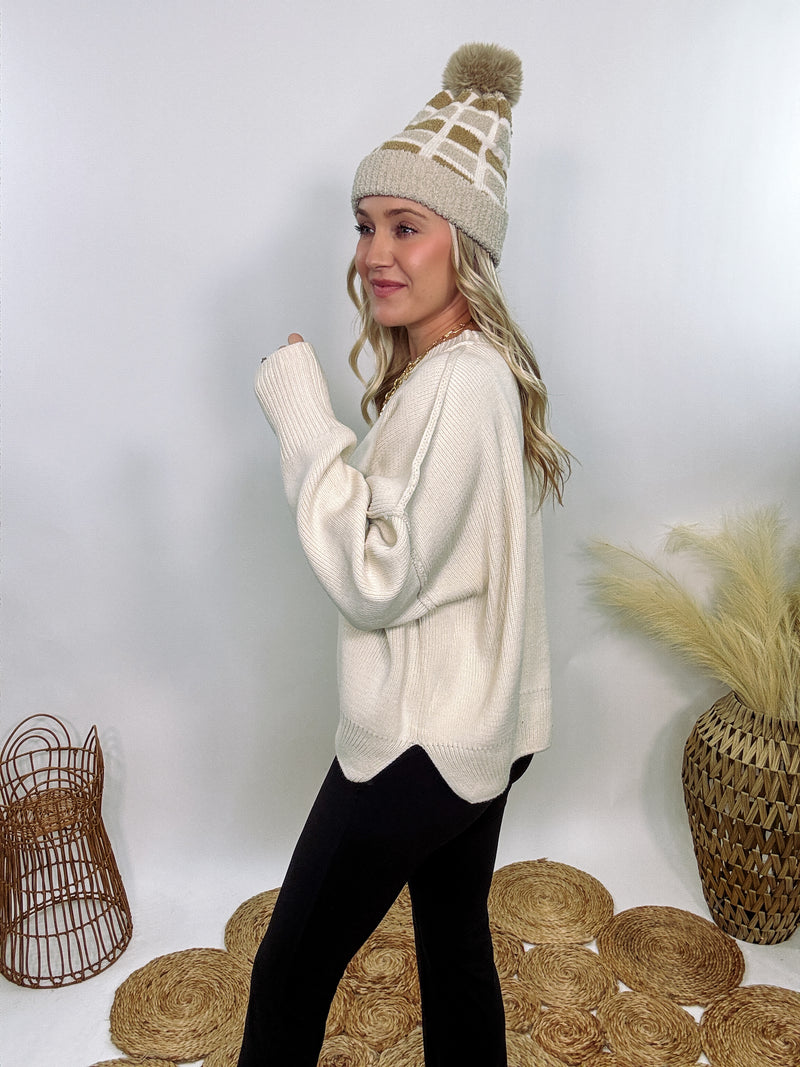 Creamy White Oversized Long Sleeve Sweater with a relaxed crew neckline, drop shoulders, ribbed knit cuffs and hem, and a soft, stretchy acrylic fabric.