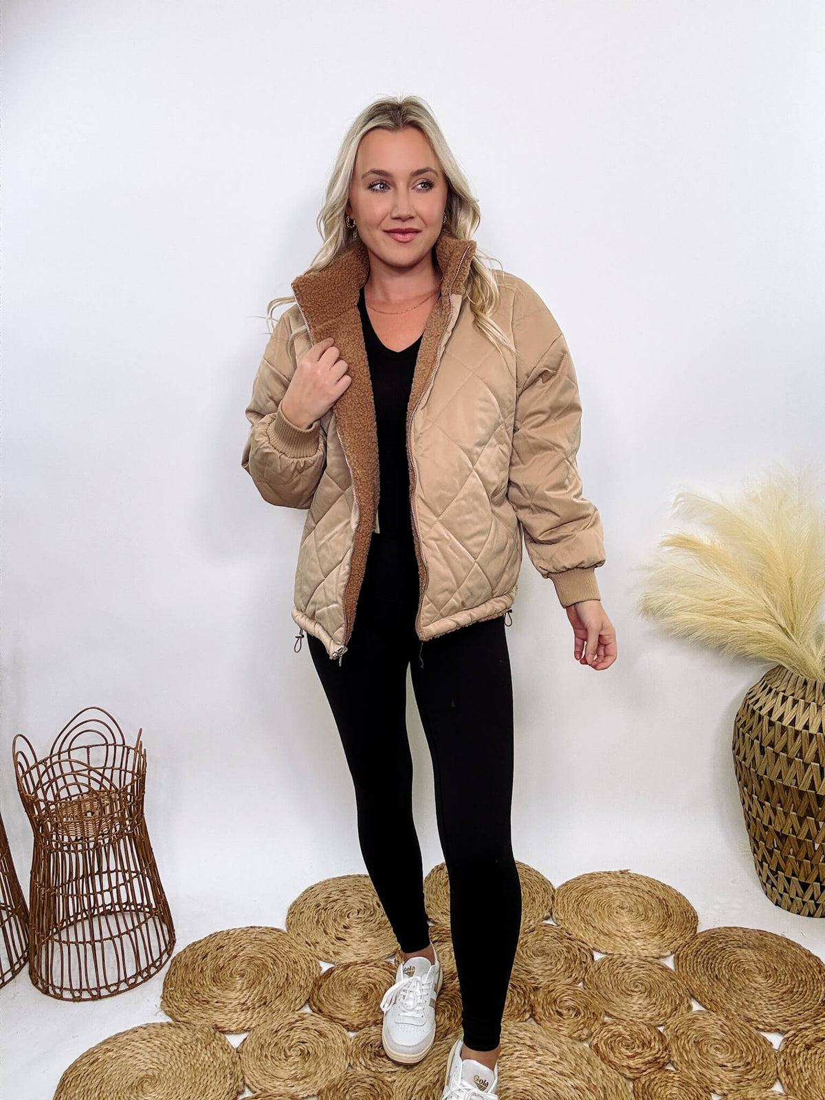 Hyfve - Embrace cozy style with our Reversible Sherpa Quilted Puffer Jacket in taupe camel. This warm, versatile jacket features a sherpa and quilted design, drop shoulders, and an adjustable waist toggle.