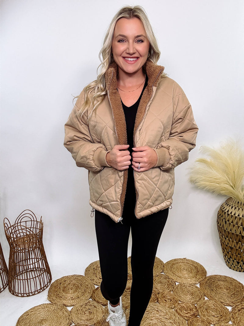 Hyfve - Embrace cozy style with our Reversible Sherpa Quilted Puffer Jacket in taupe camel. This warm, versatile jacket features a sherpa and quilted design, drop shoulders, and an adjustable waist toggle.