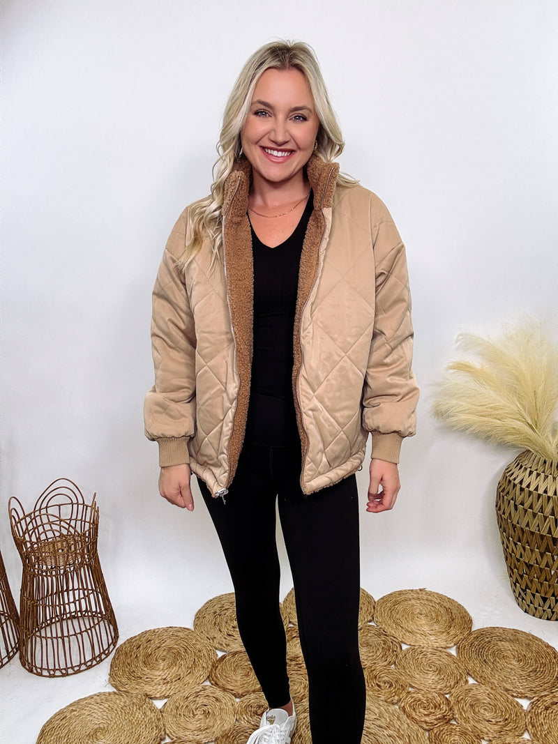 Hyfve - Embrace cozy style with our Reversible Sherpa Quilted Puffer Jacket in taupe camel. This warm, versatile jacket features a sherpa and quilted design, drop shoulders, and an adjustable waist toggle.