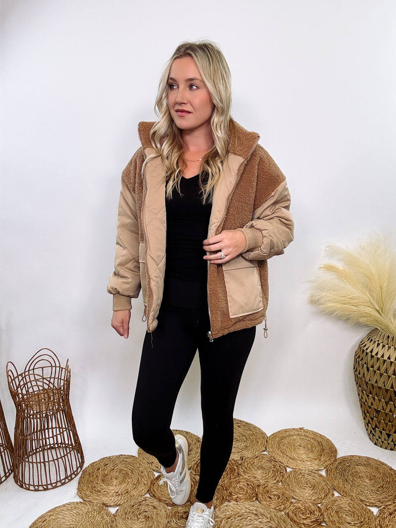 Hyfve - Embrace cozy style with our Reversible Sherpa Quilted Puffer Jacket in taupe camel. This warm, versatile jacket features a sherpa and quilted design, drop shoulders, and an adjustable waist toggle.