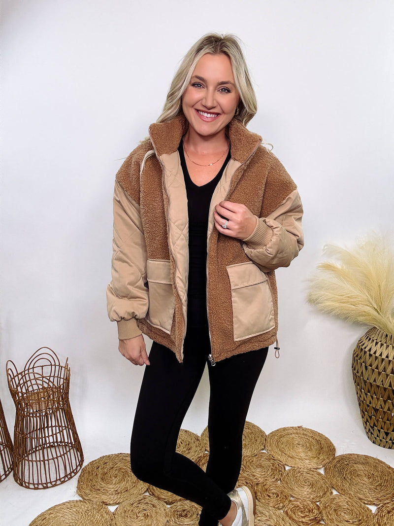 Hyfve - Embrace cozy style with our Reversible Sherpa Quilted Puffer Jacket in taupe camel. This warm, versatile jacket features a sherpa and quilted design, drop shoulders, and an adjustable waist toggle.