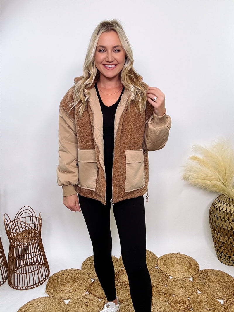 Hyfve - Embrace cozy style with our Reversible Sherpa Quilted Puffer Jacket in taupe camel. This warm, versatile jacket features a sherpa and quilted design, drop shoulders, and an adjustable waist toggle.