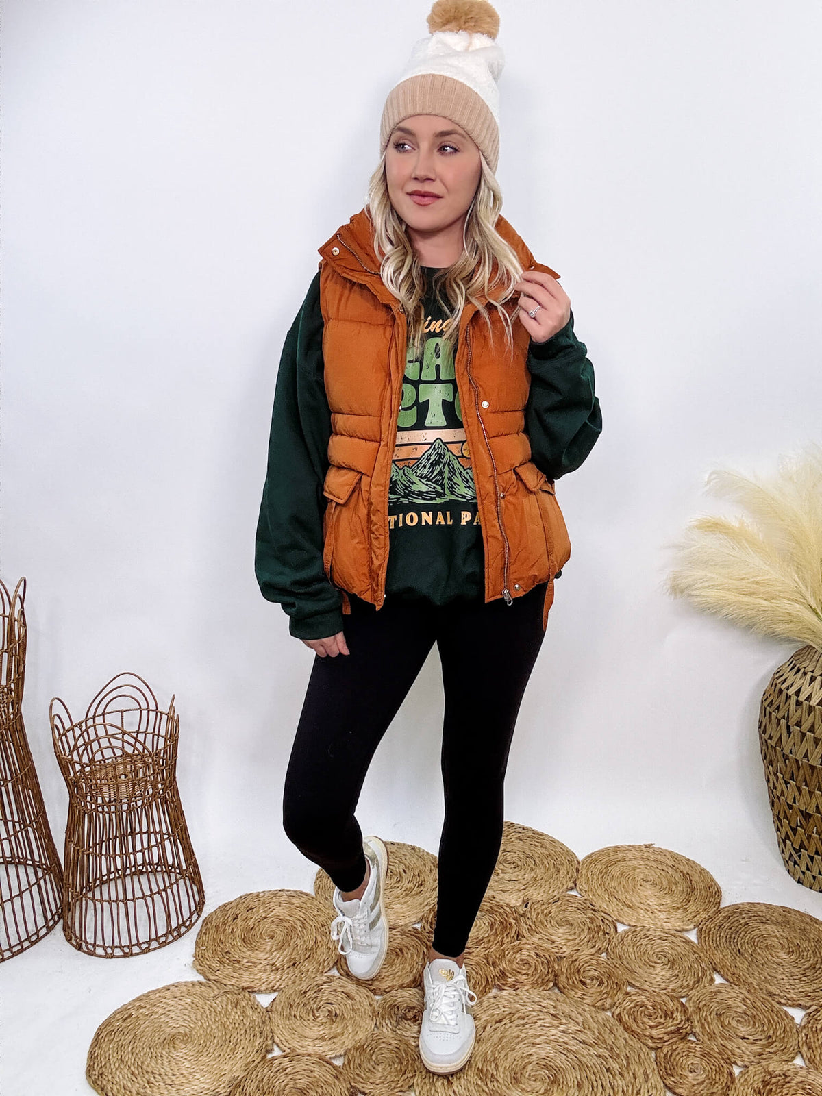 Shop the Rusty Burnt Orange Cargo Puffer Vest at Bmaes Boutique. Made from 100% polyamide, this stylish and versatile vest features two flap pockets and is perfect for layering over sweatshirts or tees.