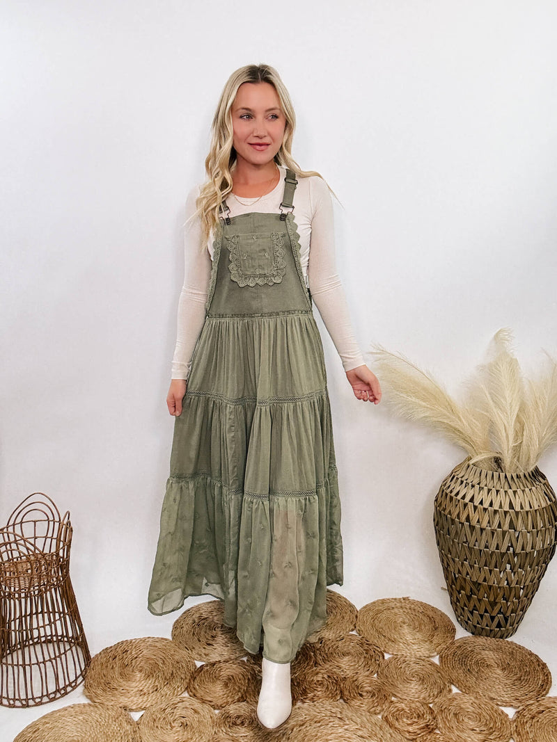 Boho olive green lace tiered overall maxi dress with adjustable straps, front chest pocket, and flowy silhouette