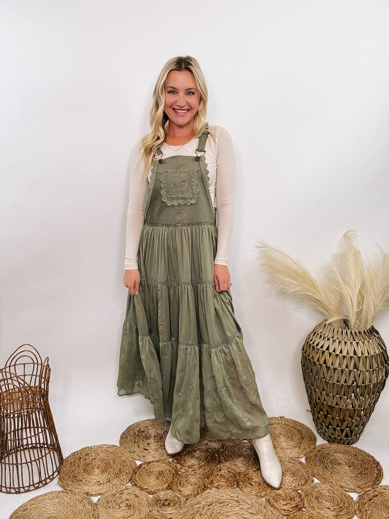 Boho olive green lace tiered overall maxi dress with adjustable straps, front chest pocket, and flowy silhouette