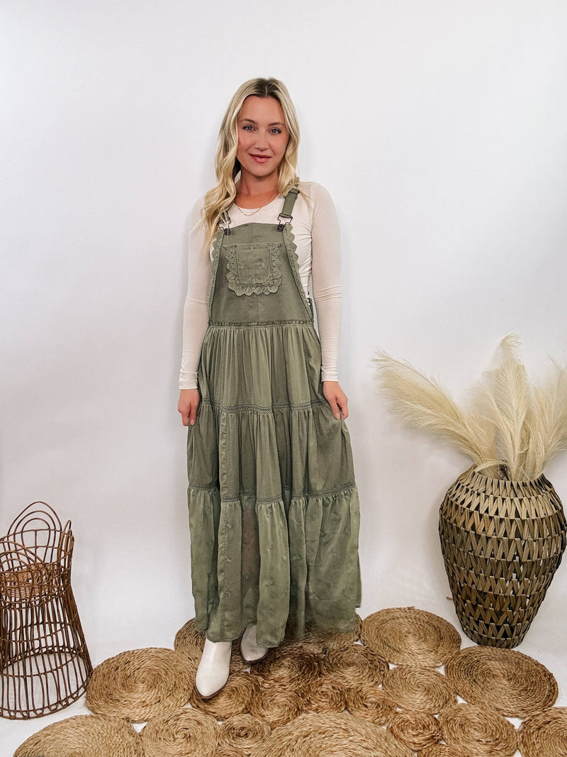 Boho olive green lace tiered overall maxi dress with adjustable straps, front chest pocket, and flowy silhouette