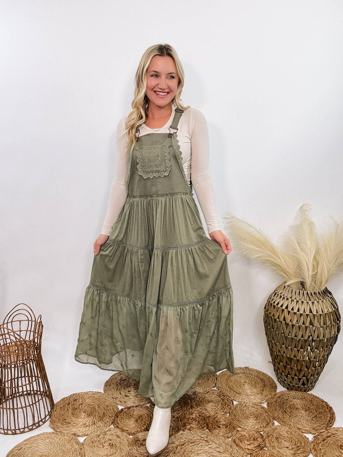 Boho olive green lace tiered overall maxi dress with adjustable straps, front chest pocket, and flowy silhouette