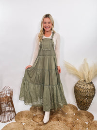 Boho olive green lace tiered overall maxi dress with adjustable straps, front chest pocket, and flowy silhouette