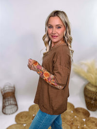 In Loom Mushroom Brown Oversized Tee with Layered Sheer Embroidered Floral Lace Mesh Sleeves – Relaxed Fit, Feminine Detailing, and Edgy Winter Style.