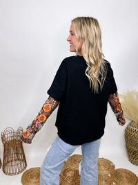 In Loom Oversized black tee with layered sheer embroidered floral lace mesh sleeves, perfect for fall with edgy vibes.