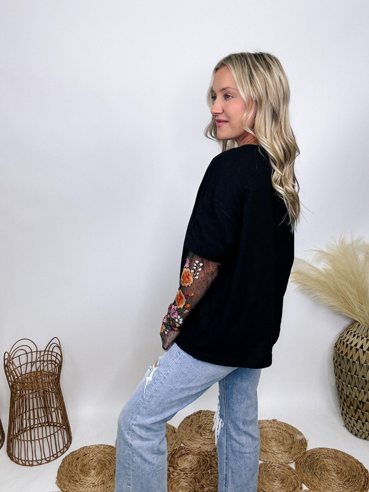 In Loom Oversized black tee with layered sheer embroidered floral lace mesh sleeves, perfect for fall with edgy vibes.