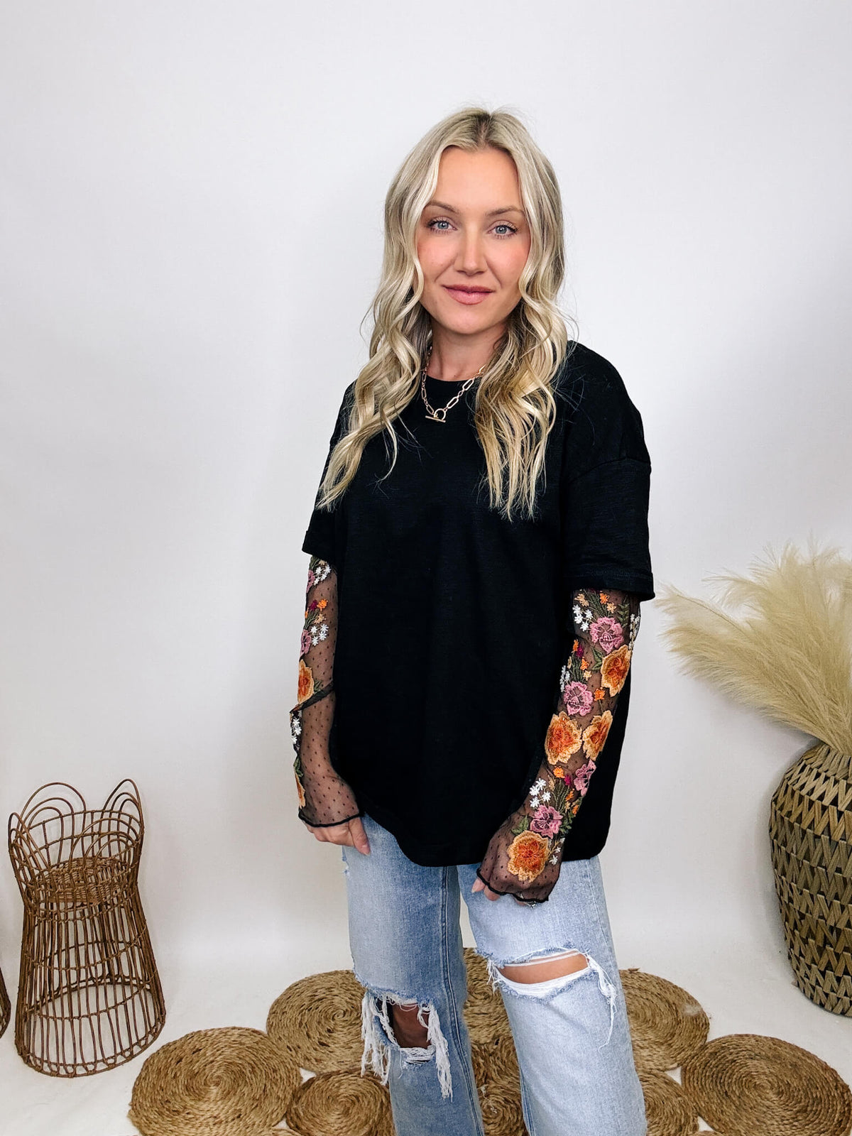 In Loom Oversized black tee with layered sheer embroidered floral lace mesh sleeves, perfect for fall with edgy vibes.