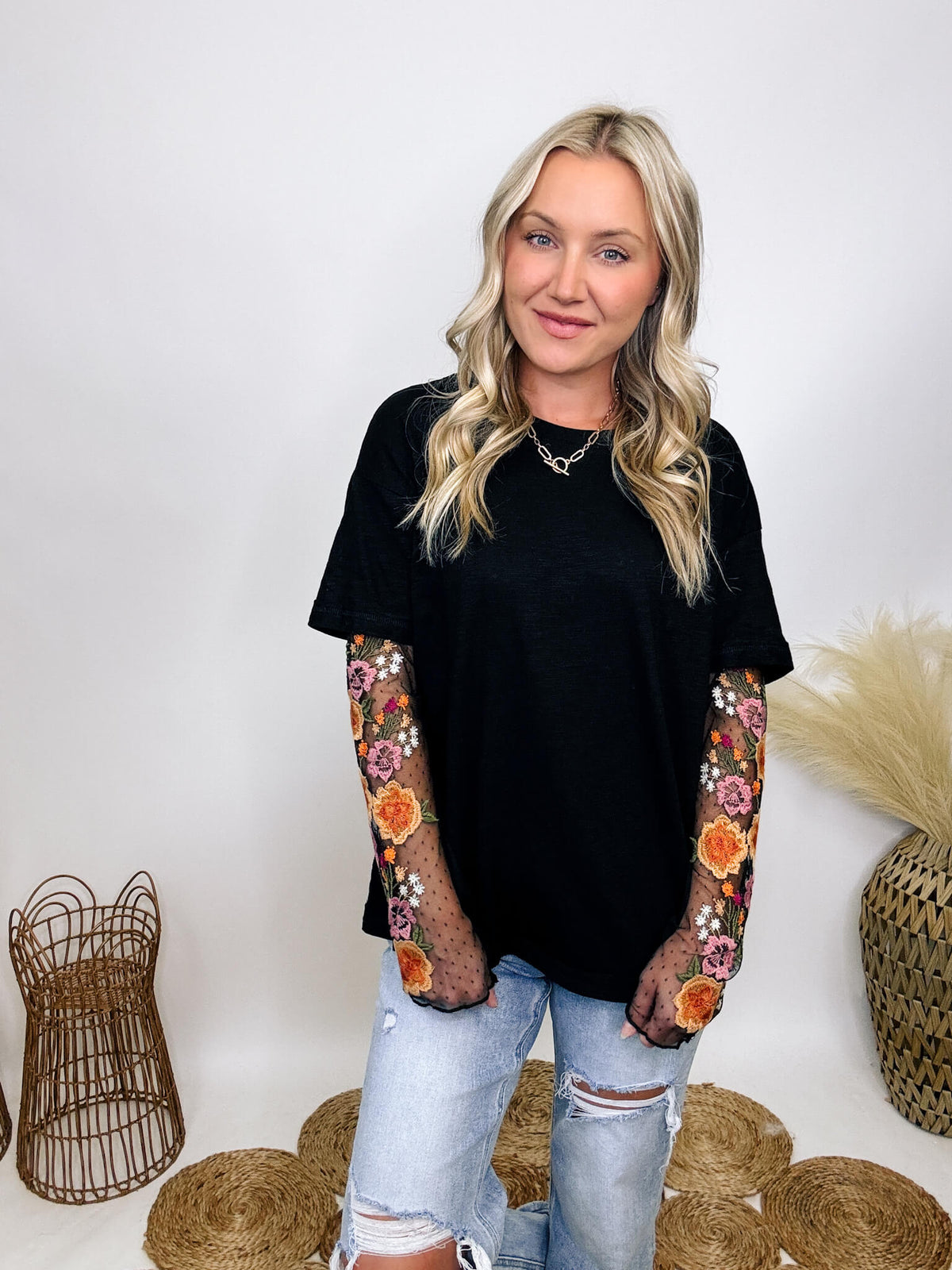 In Loom Oversized black tee with layered sheer embroidered floral lace mesh sleeves, perfect for fall with edgy vibes.