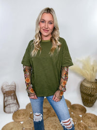 In Loom Oversized olive green tee with layered sheer embroidered floral lace mesh sleeves. Relaxed fit, earthy olive tone, and high-quality fabric blend. Perfect for casual fall outfits or dressing up with jeans or leather leggings. Feminine and edgy design ideal for crisp autumn days.