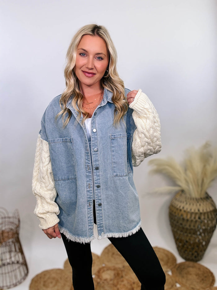 Light denim jacket with cream sweater sleeves by POL, featuring chest pockets, collared button-down front, and frayed hem.