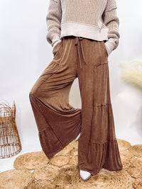 Brown Acid Washed Tiered Flared Wide Leg Boho Pants with Elastic Drawstring Waist, Side Pockets, and Comfortable 100% Cotton Fabric.