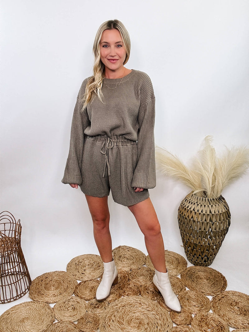 Mable Mushroom long sleeve sweater romper with drawstring waist, styled with knee-high boots, heels, or sneakers for fall