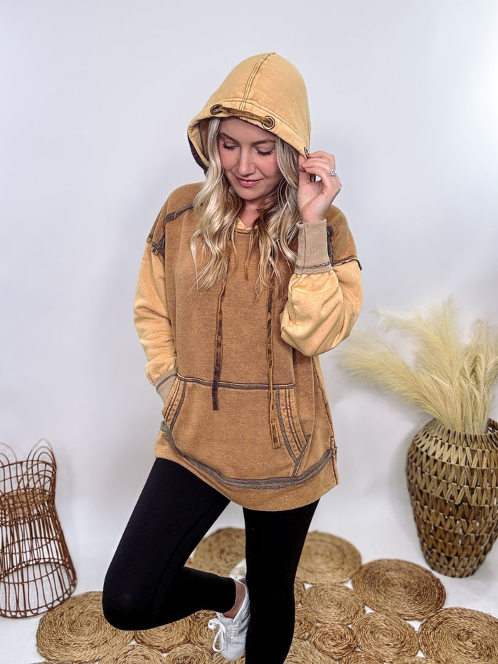 Neutral mineral-washed fleece-lined hoodie by Oli & Hali with a relaxed fit, front kangaroo pocket, side slits, exposed seam details, and drawstring hood. Made from a high-quality cotton, polyester, and spandex blend, perfect for winter layering.