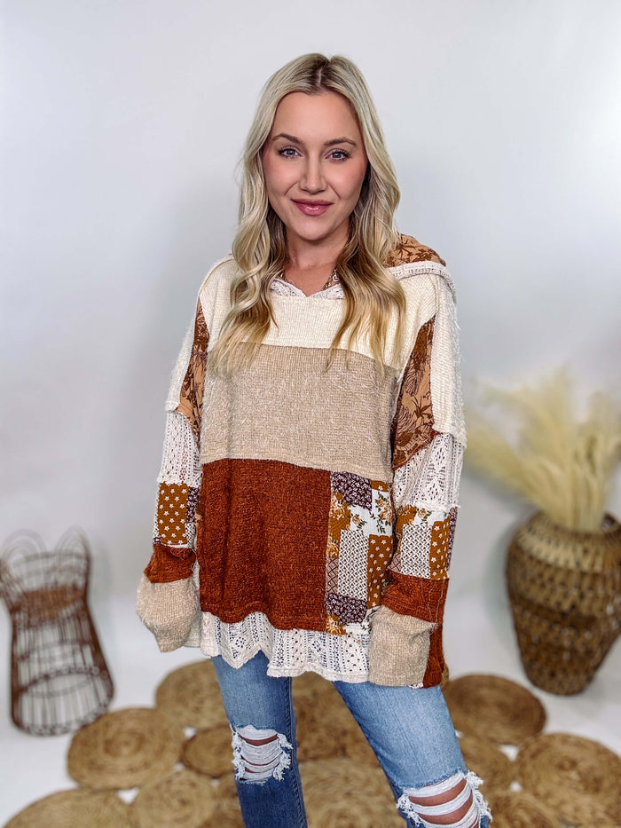 Boho patchwork oversized hoodie by Oli & Hali featuring lace and floral details in rust, tan, beige, and cream. Oversized fit with side pockets, made from high-quality materials including polyester, spandex, rayon, nylon, and cotton. Size down for a more tailored look. Perfect for pairing with leggings or dressing up with denim and booties.