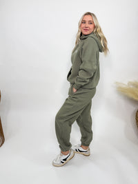 Olive green fleece-lined luxury lounge Bmaes hoodie with embroidered Bmaes Boutique logo, drop shoulders, kangaroo pocket, and ribbed details. Perfect for cozy lounging or pairing with the matching joggers for a stylish, warm set from Bmaes Boutique.