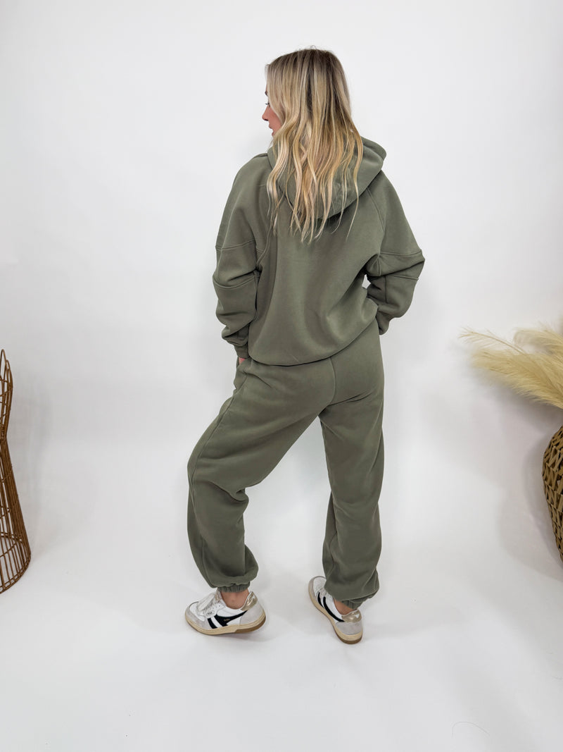 Olive green fleece-lined luxury lounge Bmaes hoodie with embroidered Bmaes Boutique logo, drop shoulders, kangaroo pocket, and ribbed details. Perfect for cozy lounging or pairing with the matching joggers for a stylish, warm set from Bmaes Boutique.