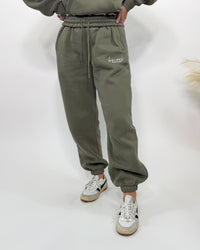 Olive green fleece-lined luxury lounge Bmaes joggers with elastic drawstring waistband, deep pockets, and elastic ankle cuffs. Perfect for lounging or pairing with the matching hoodie for a stylish, cozy set from Bmaes Boutique.