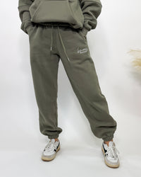 Olive green fleece-lined luxury lounge Bmaes joggers with elastic drawstring waistband, deep pockets, and elastic ankle cuffs. Perfect for lounging or pairing with the matching hoodie for a stylish, cozy set from Bmaes Boutique.