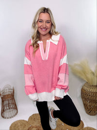 Pink Polo Preppy Style Sweater with ivory stripe patches on the sleeves and neckline, featuring a collared split neck design, long sleeves, high-low cut, and oversized fit, made of 100% polyester.