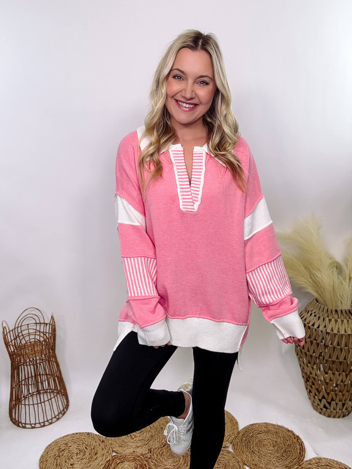 Pink Polo Preppy Style Sweater with ivory stripe patches on the sleeves and neckline, featuring a collared split neck design, long sleeves, high-low cut, and oversized fit, made of 100% polyester.