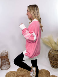 Pink Polo Preppy Style Sweater with ivory stripe patches on the sleeves and neckline, featuring a collared split neck design, long sleeves, high-low cut, and oversized fit, made of 100% polyester.