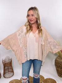 POL Neutral Cream Mix Short Sleeve V-Neck Oversized Knit Top with crochet and thermal patchwork, frayed edges, and exposed seams for a comfy, boho chic look.