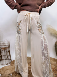 POL Lace and Floral Wide Leg Boho Pants in cream with floral accents and lace details.