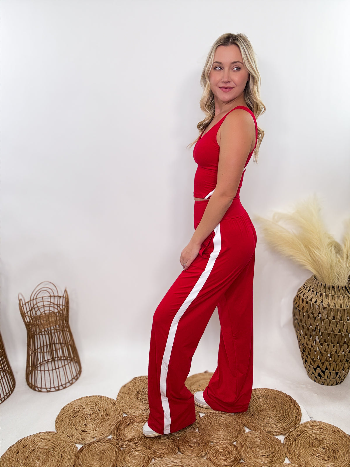 Red & White Sporty Matching Lounge Set featuring a V-neck crop tank with contrast white piping and high-waisted straight-leg pants. Designed with a relaxed fit, 4-way stretch fabric, and sporty chic details, perfect for lounging, workouts, and casual outings.