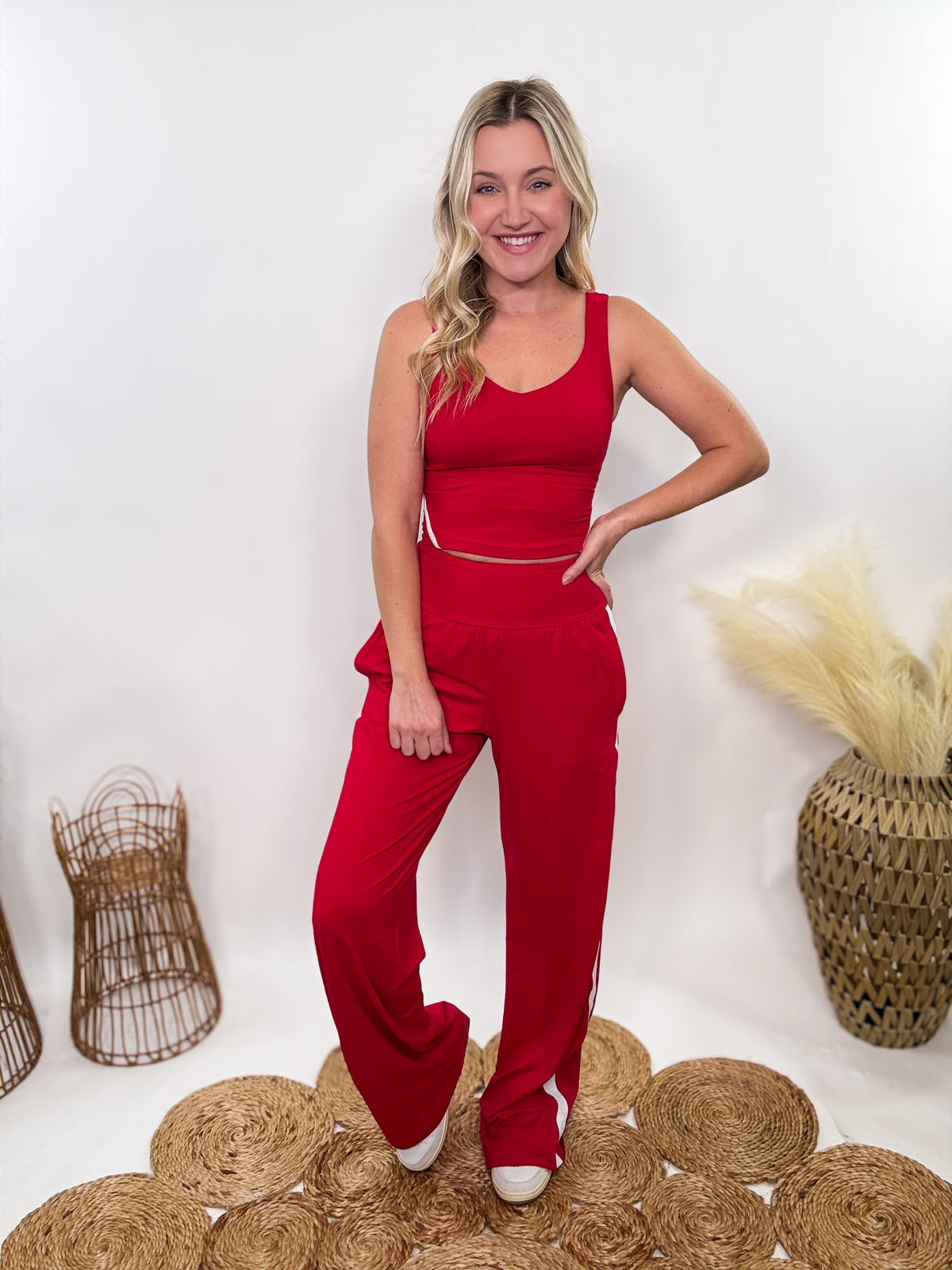 Red & White Sporty Matching Lounge Set featuring a V-neck crop tank with contrast white piping and high-waisted straight-leg pants. Designed with a relaxed fit, 4-way stretch fabric, and sporty chic details, perfect for lounging, workouts, and casual outings.