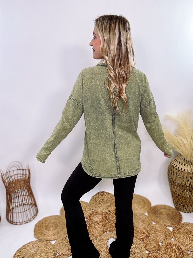 Sage Green Acid Washed Long Sleeve Top with Raw Edge Detail, Chest Pocket, and Relaxed Fit – Perfect for Casual Outfits with Leggings and Sneakers.